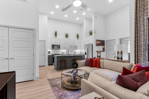 A modern living room with a beige sofa and a wooden coffee table.